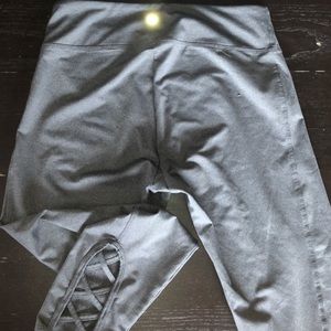 gray athletic leggings with crossed ankles
